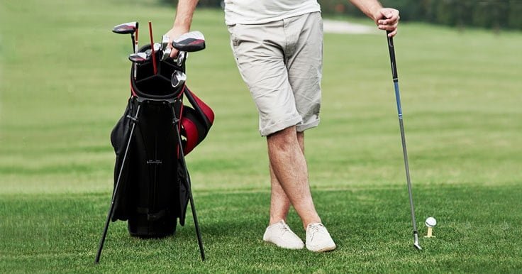 Golfer with golf stand bag
